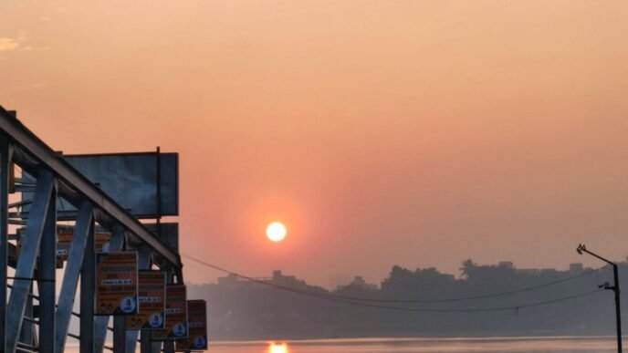 the sun is setting over a body of water